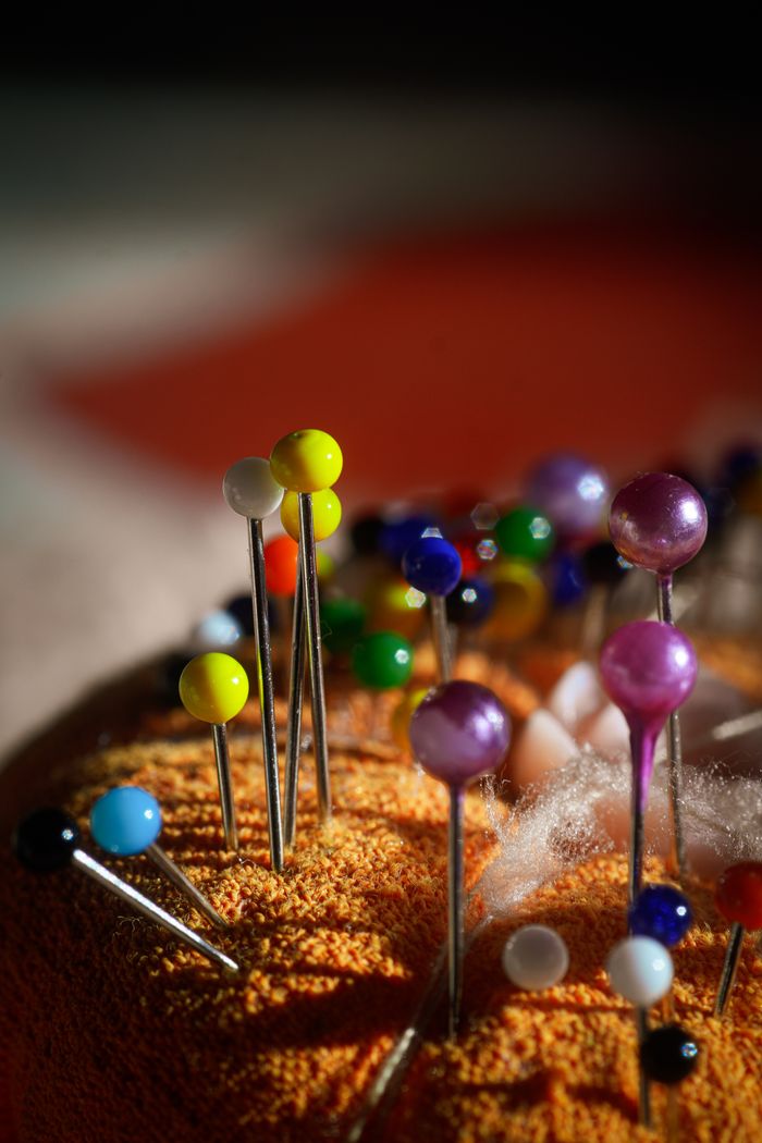 Crafting Captivating Headlines: Your awesome post title goes here Close-up of colorful sewing pins on a cushion, highlighting creativity in vibrant lighting.