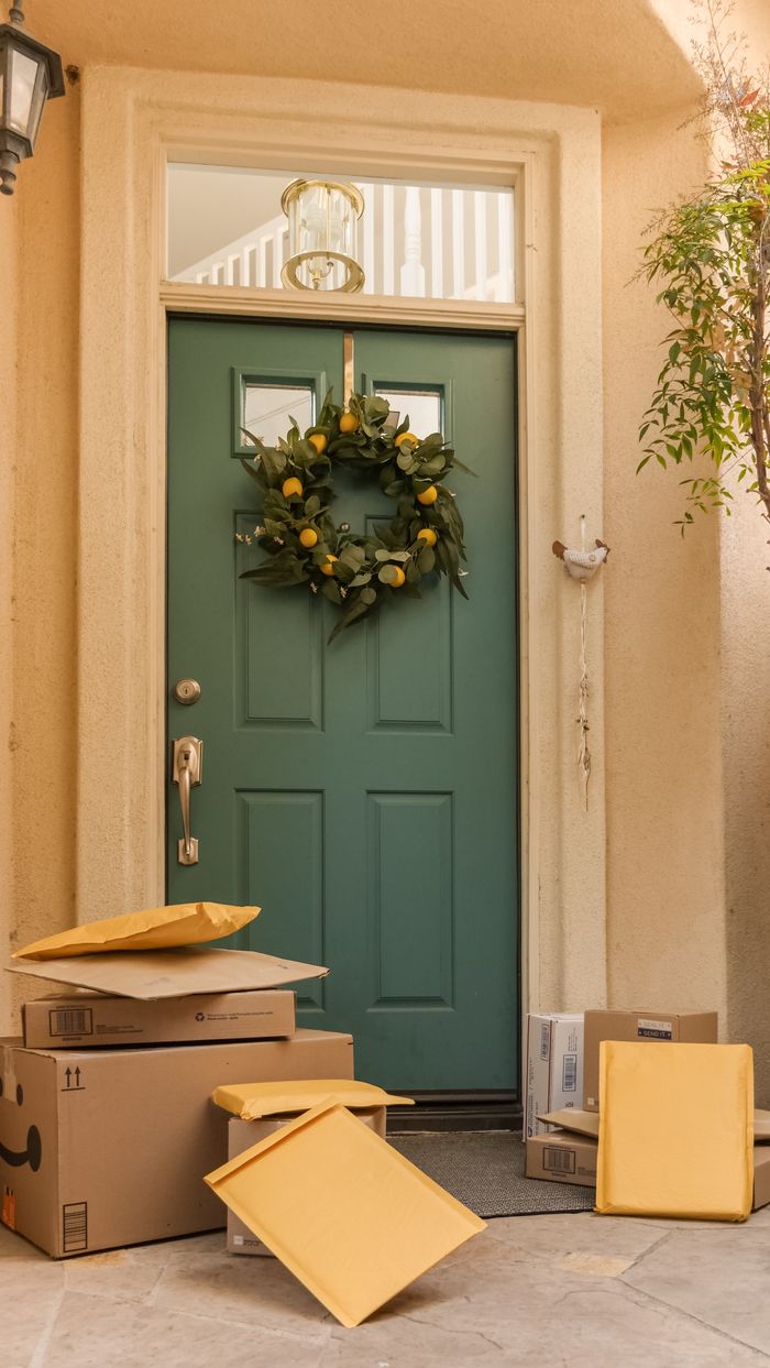 Services A welcoming entrance with a green wreath and several packages by the door.